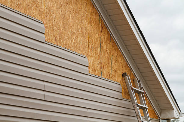 Professional Storm Damage Siding Repair technician working in Fayetteville, OH
